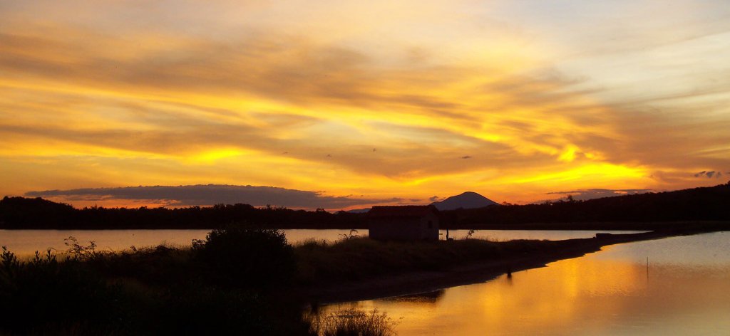 Panoramic sunset at Salinera Santa Alejandra and lagoons where shorebirds nest and feed